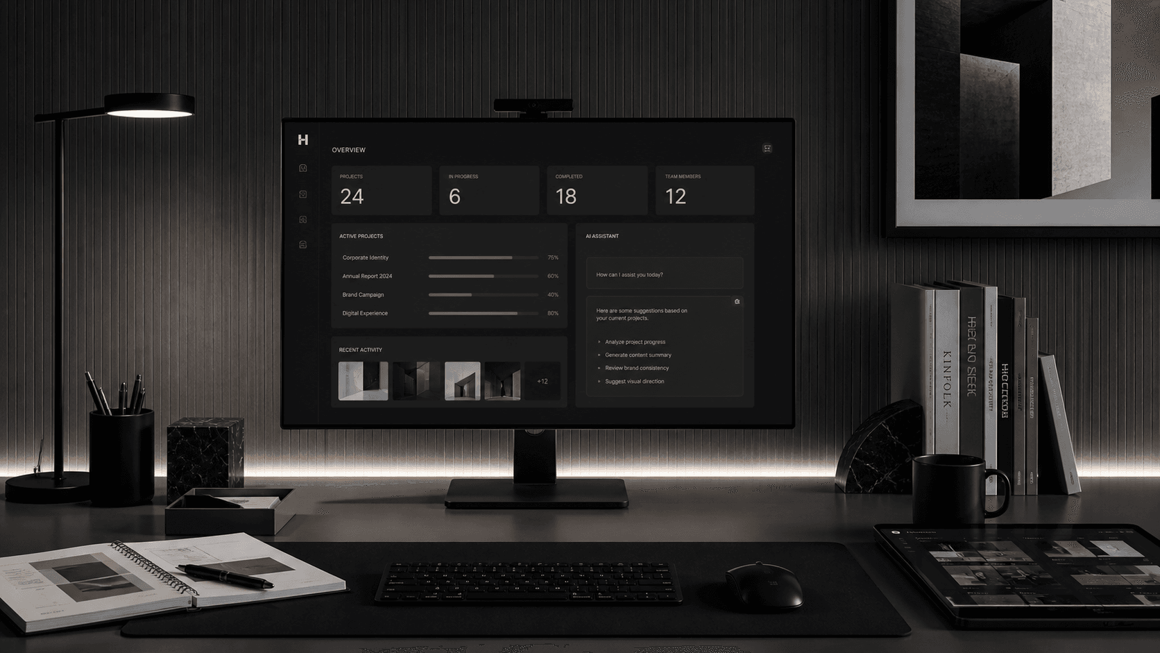Monochrome workspace with a dashboard interface, books, and structured desk layout.
